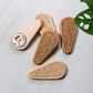 Wooden bottle openers with unique patterns on a light gray surface.