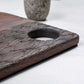 Wooden cutting board with textured surface on a white background